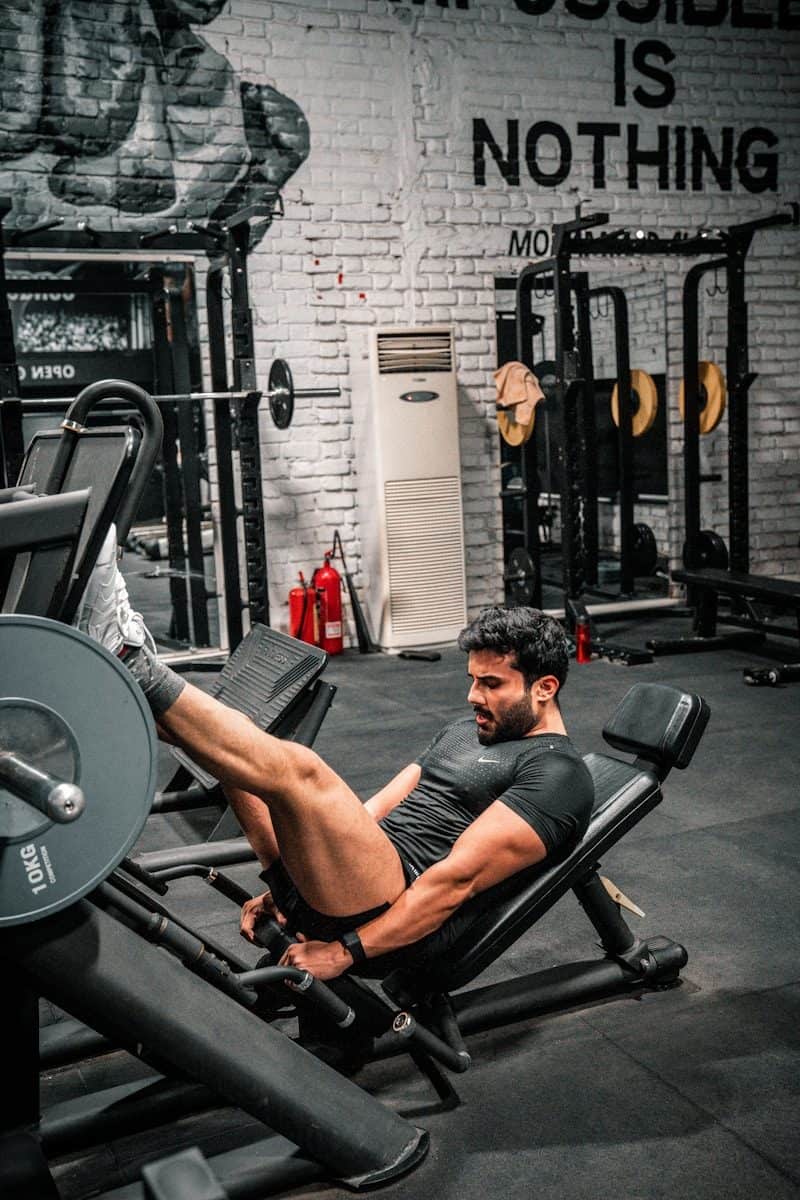 Man is working out on a leg press machine