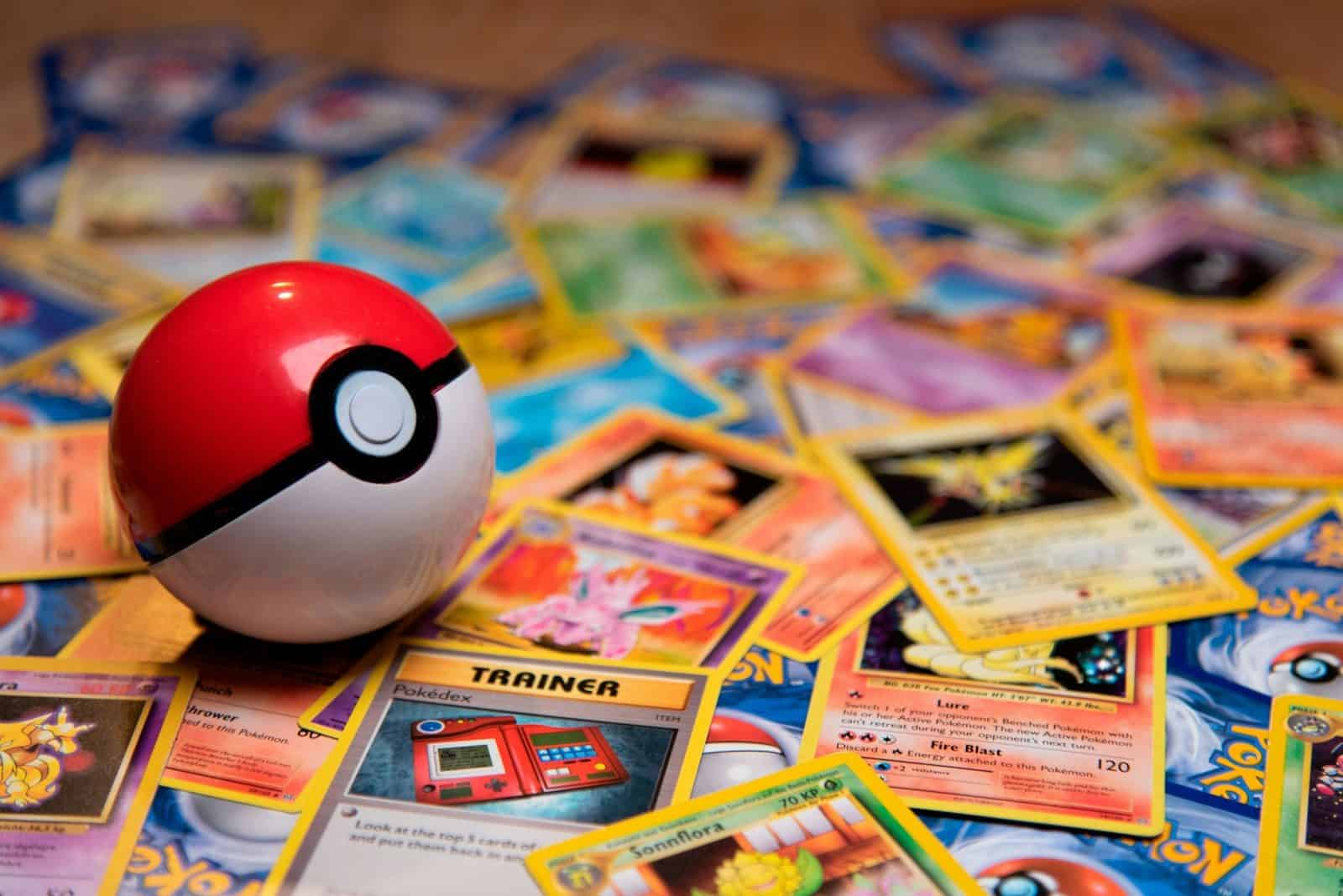 A red and white plastic ball resting on a pile of trading cards