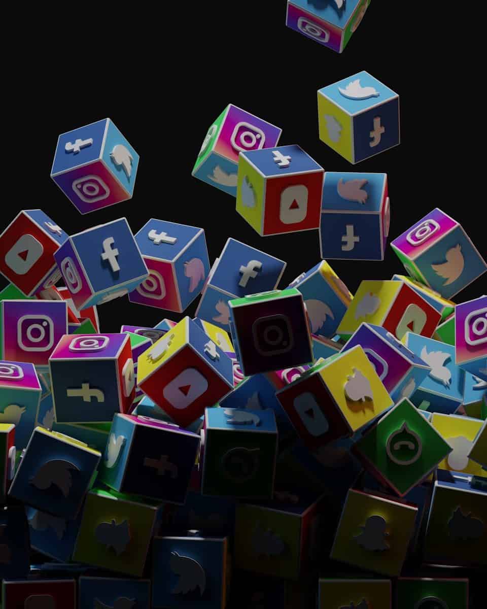 a pile of colorful cubes with social icons flying out of them