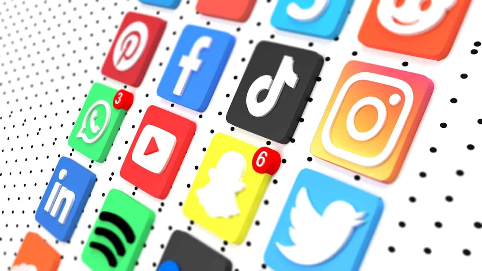 A grid of colorful three-dimensional social media icons on a white dotted background