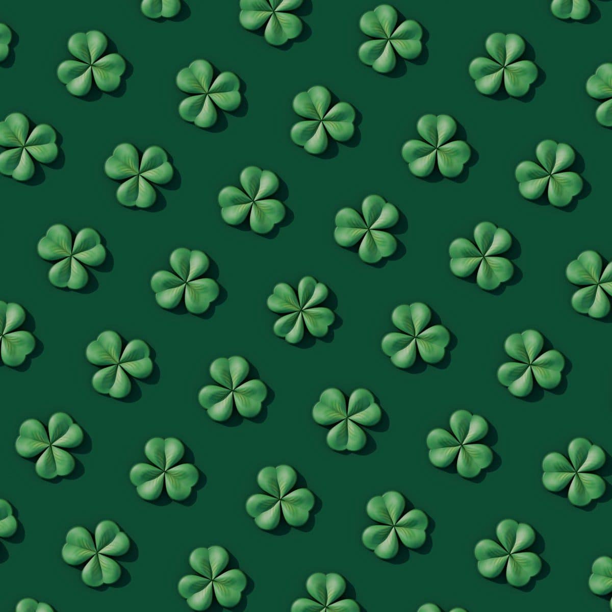 a green background with four leaf clovers