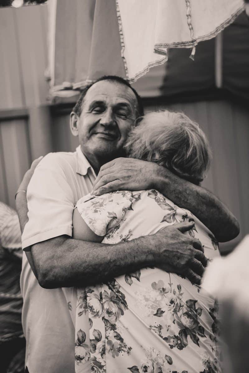 grayscale photography of man and woman embracing