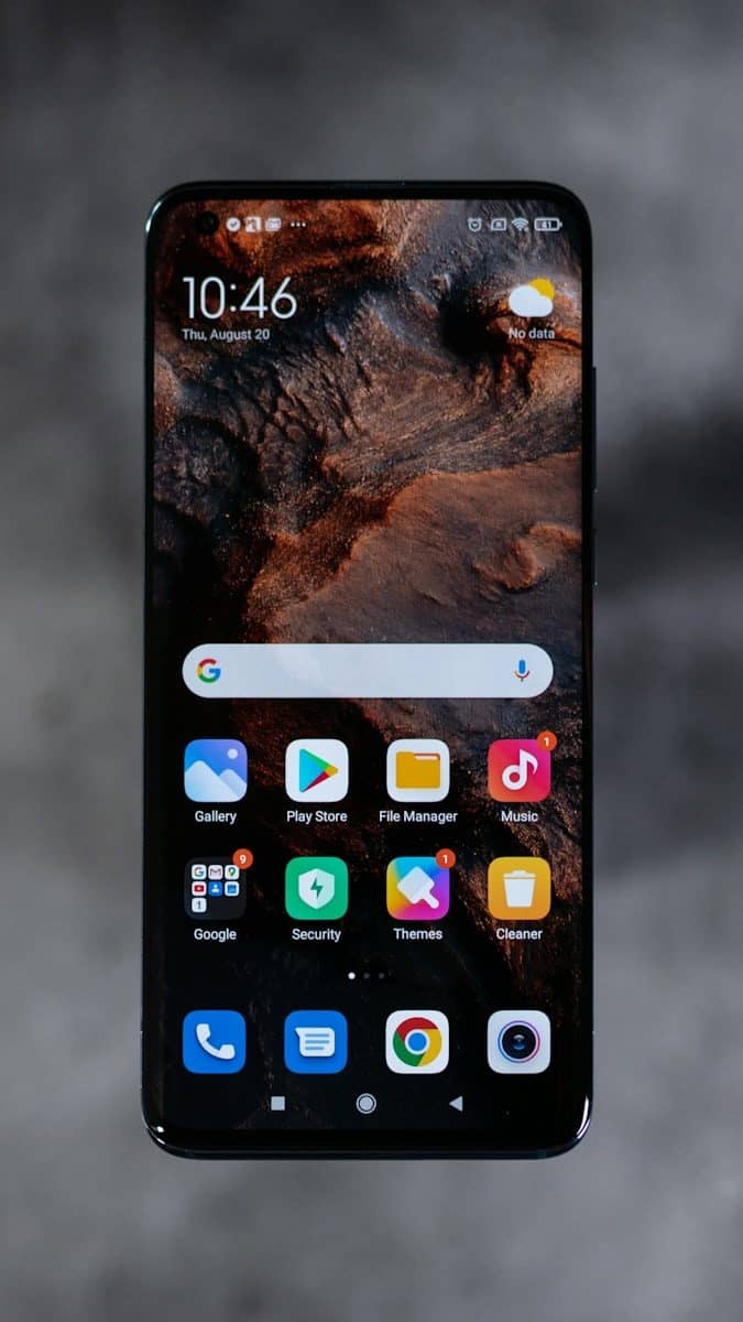 A smartphone screen displaying a home screen with various app icons and widgets