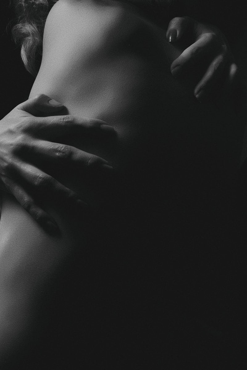 A person with hands resting on their waist in a black and white photograph