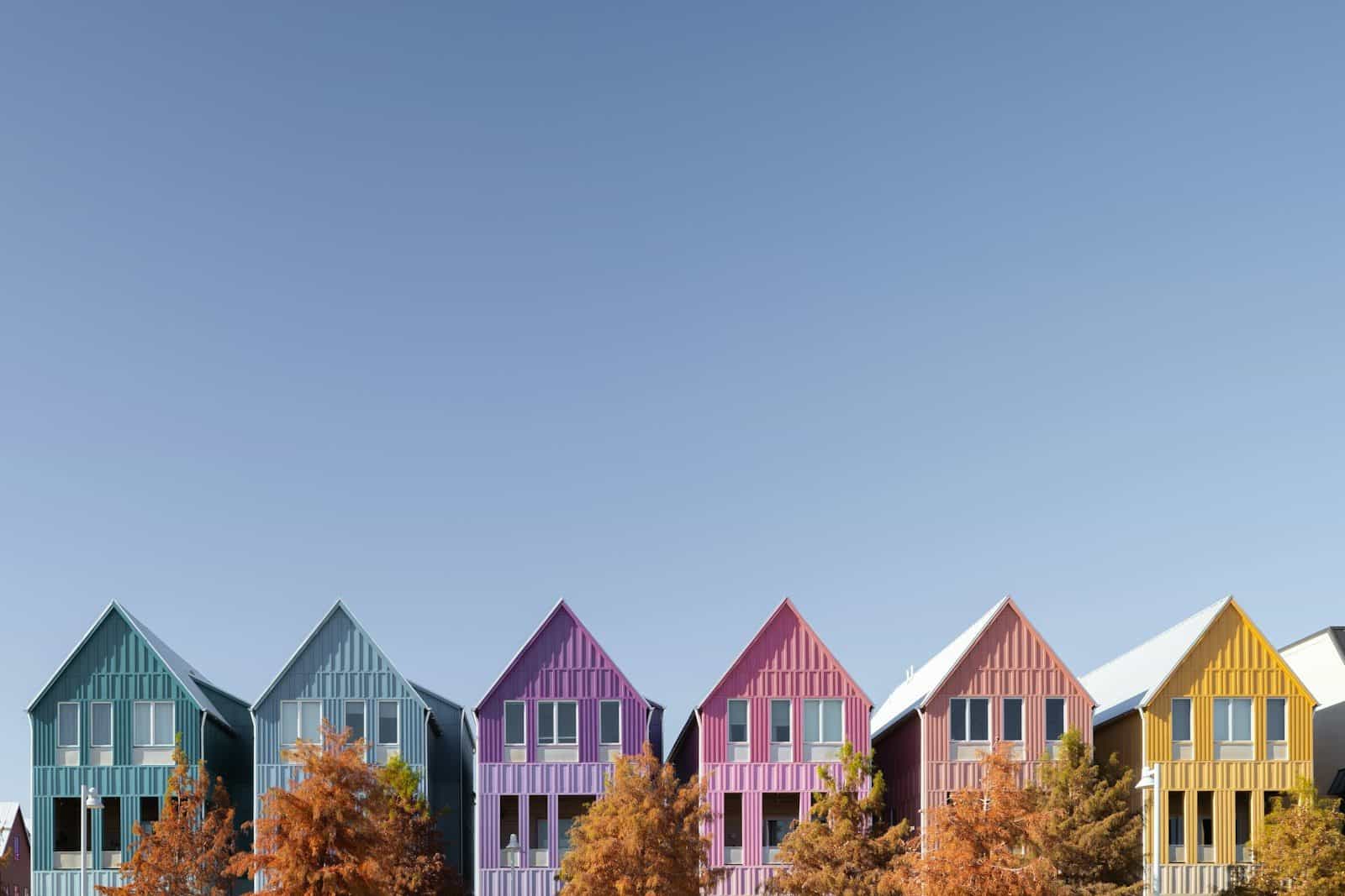 Colorful houses line a bright blue sky