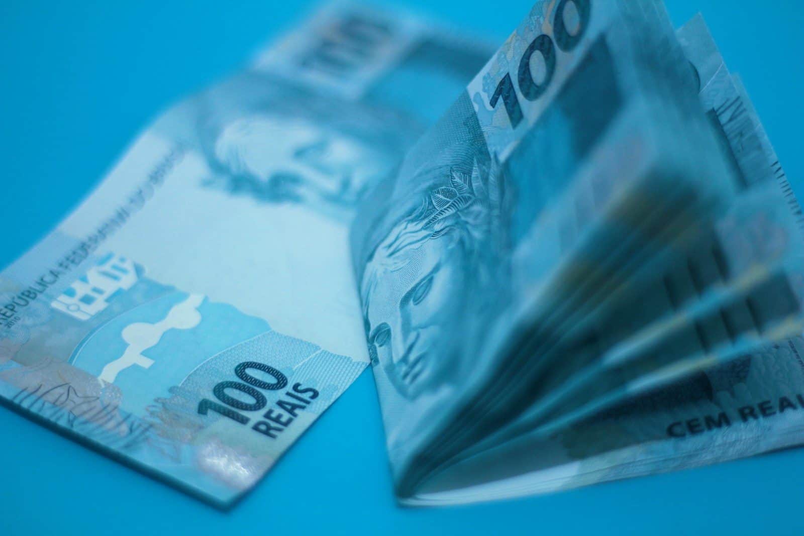 A pile of money sitting on top of a blue table