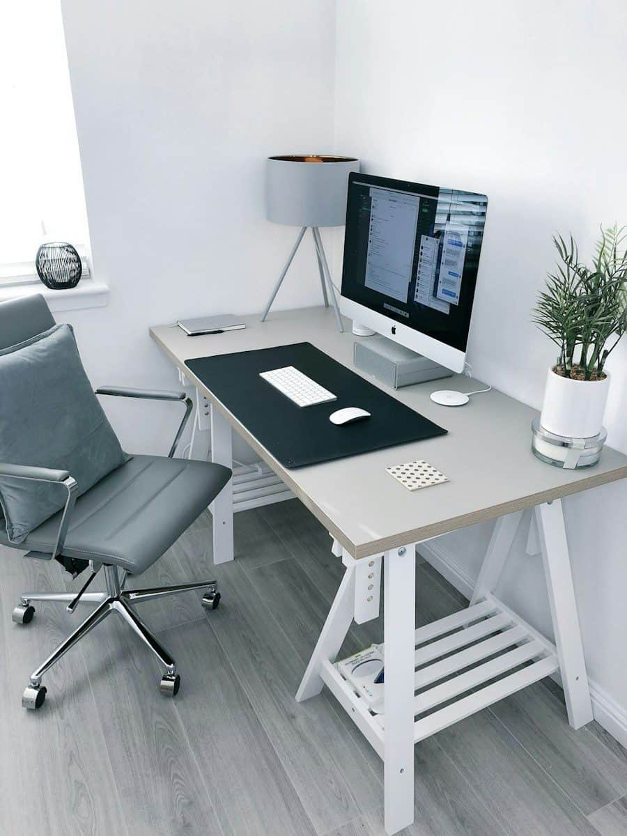 gray leather office rolling armchair beside white wooden computer desk