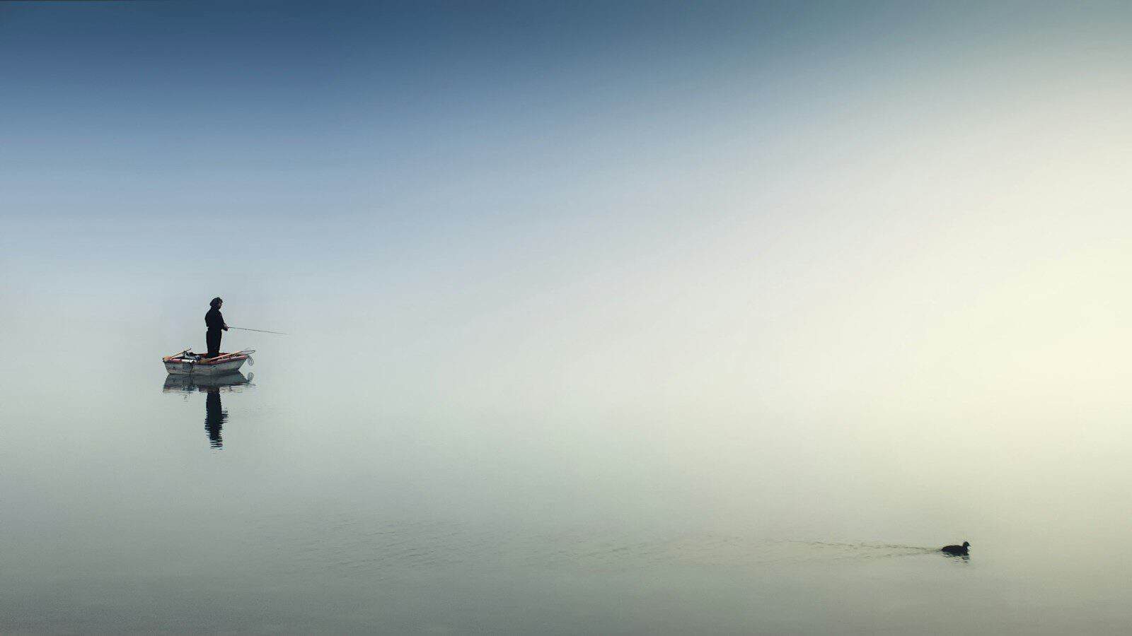 rule of thirds photography of man on boat