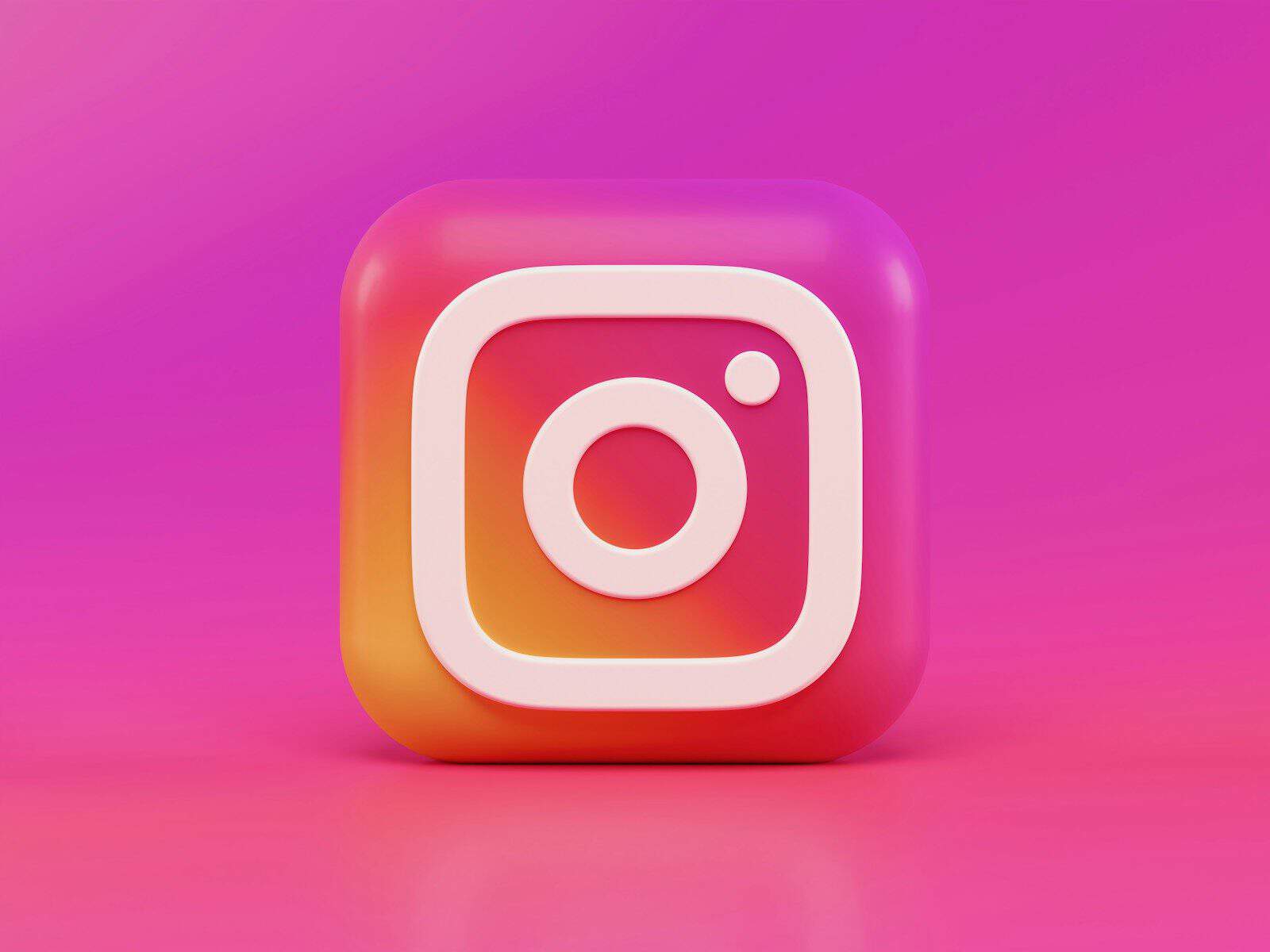 A three-dimensional Instagram logo icon with a pink and orange gradient background