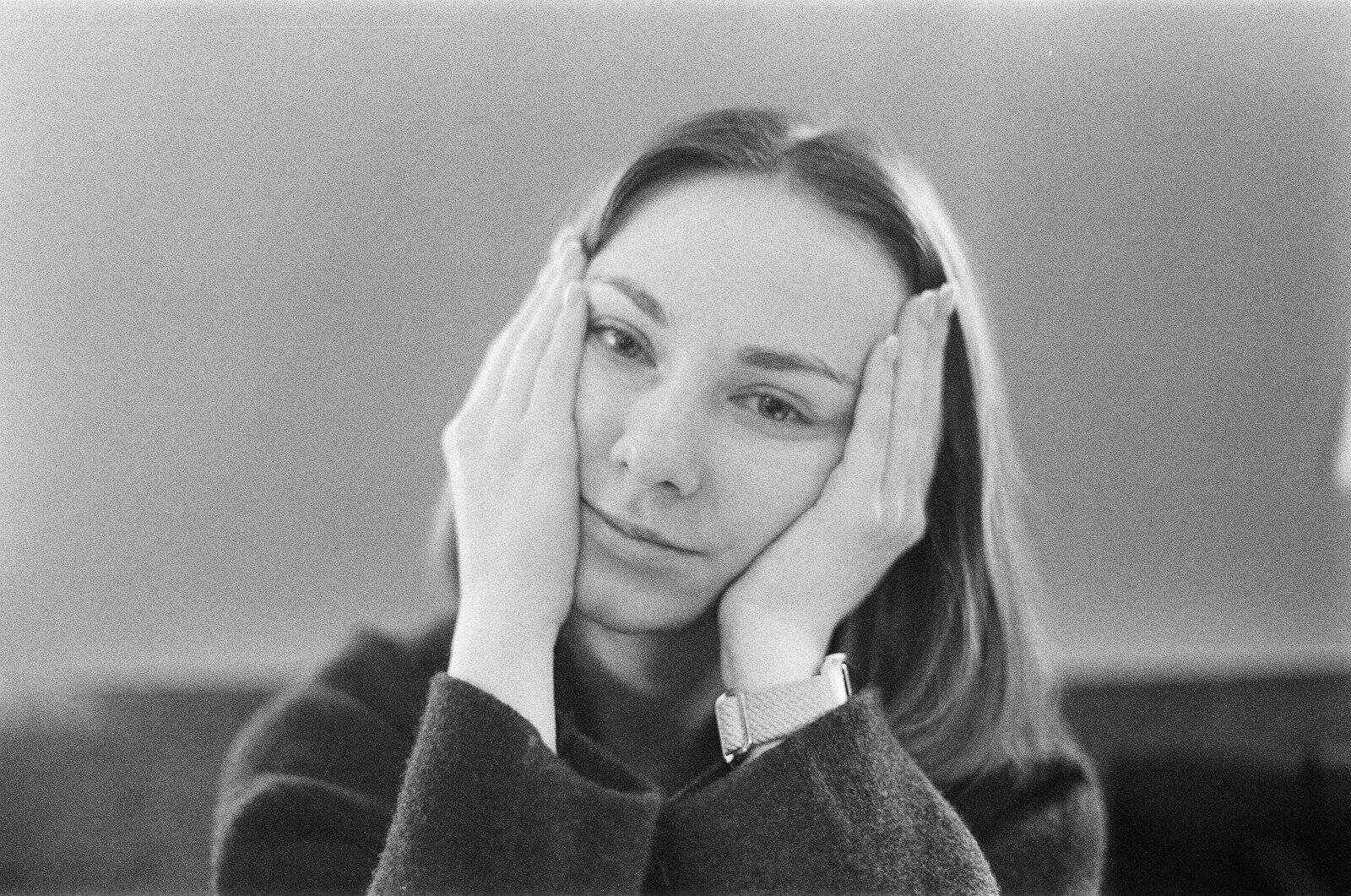 A woman rests her face in her hands