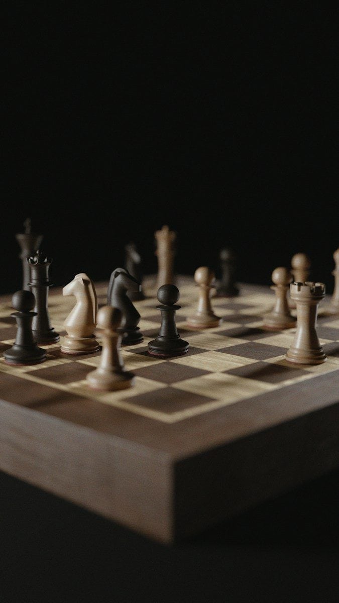 Chess pieces arranged on a wooden board