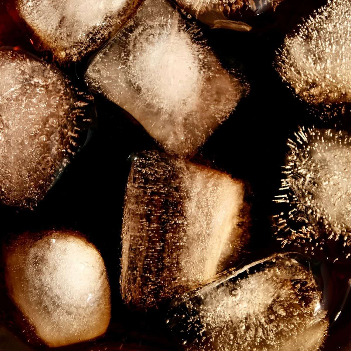 Close-up of ice cubes in dark liquid