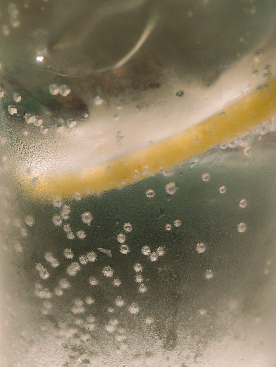 Close-up of a lemon slice in a bubbly drink