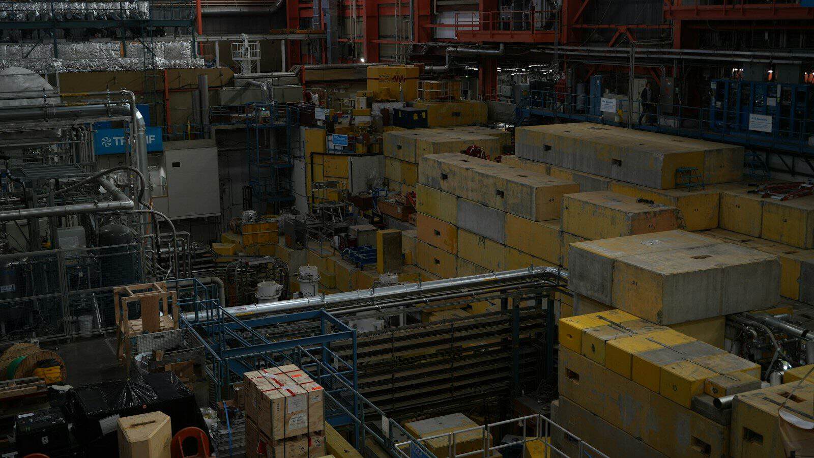 A cluttered industrial facility with numerous boxes and machinery